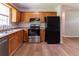 A well-lit kitchen featuring wood cabinets, stainless steel appliances, and modern wood-look flooring at 67 Jennifer Ln, Rydal, GA 30171