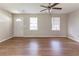 The living room is bright with neutral paint, three windows, and new wood-look flooring at 67 Jennifer Ln, Rydal, GA 30171