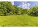 Lush green yard surrounded by mature trees, creating a private and peaceful setting at 67 Jennifer Ln, Rydal, GA 30171
