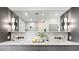 Bathroom with dual sinks, modern wall mounted lighting, and a large mirror at 726 Edgewood Ne Ave, Atlanta, GA 30307