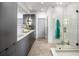 Modern bathroom with a glass-enclosed shower and sleek gray cabinets at 726 Edgewood Ne Ave, Atlanta, GA 30307