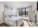 Bright bedroom featuring a plush bed, large window, and stylish decor; filled with natural light and modern accents at 726 Edgewood Ne Ave, Atlanta, GA 30307
