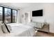 Well-lit bedroom with a large window, mirrored dresser, and TV; perfect for relaxation and entertainment at 726 Edgewood Ne Ave, Atlanta, GA 30307