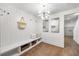 Contemporary entryway with decorative lighting, built-in bench, and light hardwood floors at 726 Edgewood Ne Ave, Atlanta, GA 30307
