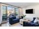 Chic living room featuring two blue sofas, sliding glass doors opening to an outside patio area, and modern decor at 726 Edgewood Ne Ave, Atlanta, GA 30307