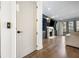 Bright living room showcasing a fireplace, large screen TV, balcony access, and beautiful hardwood floors at 726 Edgewood Ne Ave, Atlanta, GA 30307