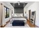 A modern primary bedroom with a tray ceiling, accent wall, and plush bedding at 726 Edgewood Ne Ave, Atlanta, GA 30307