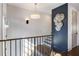 An elegant staircase with a designer chandelier and modern metal railing at 726 Edgewood Ne Ave, Atlanta, GA 30307