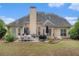 Inviting backyard with patio, dining set, grill and lush greenery at 113 Glenmore Ln, Mcdonough, GA 30253