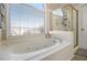Bathroom featuring a soaking tub with separate shower at 113 Glenmore Ln, Mcdonough, GA 30253
