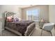 Cozy bedroom with a large window and comfortable looking bed with mirrored decorative headboard at 113 Glenmore Ln, Mcdonough, GA 30253