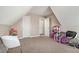 Bedroom with slanted roof with toys and games along walls at 113 Glenmore Ln, Mcdonough, GA 30253