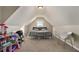 Large bedroom with angled ceilings, carpet, and a window for natural light at 113 Glenmore Ln, Mcdonough, GA 30253