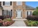Close-up of the home's entry with beautiful stone work and landscaping, creating a welcoming approach at 113 Glenmore Ln, Mcdonough, GA 30253