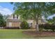 Charming two-story home featuring a brick facade, lush landscaping, and a well-manicured lawn at 113 Glenmore Ln, Mcdonough, GA 30253