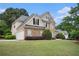 Lovely two-story home with a stone facade, lush landscaping, and attached two-car garage at 113 Glenmore Ln, Mcdonough, GA 30253