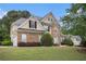 Beautiful two-story home with a stone facade, manicured lawn, and attached two-car garage at 113 Glenmore Ln, Mcdonough, GA 30253