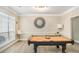 Game room features a billiard table and designer mirror and lighting at 113 Glenmore Ln, Mcdonough, GA 30253