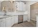 Kitchen with stainless steel dishwasher, white cabinets and light countertops at 113 Glenmore Ln, Mcdonough, GA 30253