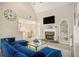 Bright living room featuring a stone fireplace, cathedral ceiling and a stylish blue sectional sofa at 113 Glenmore Ln, Mcdonough, GA 30253