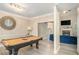 Open recreation room with a pool table, elegant lighting, and a view into the living area at 113 Glenmore Ln, Mcdonough, GA 30253