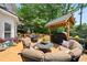 Inviting back deck features an outdoor kitchen, elegant seating, and lush, private wooded surroundings at 1703 Brandywine Ct, Atlanta, GA 30338