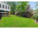 Backyard featuring a lush green lawn, a pergola with seating, and a hot tub at 1703 Brandywine Ct, Atlanta, GA 30338