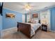 Stylish bedroom with bright blue walls, framed art, and a comfortable queen bed at 1703 Brandywine Ct, Atlanta, GA 30338
