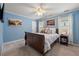 A bedroom with blue walls, wood trim, and updated carpet and furnishings, exuding a cozy ambiance at 1703 Brandywine Ct, Atlanta, GA 30338
