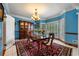 Elegant dining room featuring a large window, chandelier, and custom china cabinet at 1703 Brandywine Ct, Atlanta, GA 30338