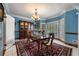 Bright dining room with shuttered windows, chandelier, and classic furnishings at 1703 Brandywine Ct, Atlanta, GA 30338