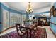 Elegant dining room with hardwood table, chair rail detail, and direct access to living room at 1703 Brandywine Ct, Atlanta, GA 30338