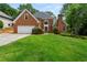 Charming two-story brick home with well-manicured lawn and attached two car garage at 1703 Brandywine Ct, Atlanta, GA 30338