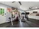 A well-equipped home gym features rubber floors and exercise equipment with a kitchenette in the background at 1703 Brandywine Ct, Atlanta, GA 30338