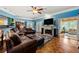 Spacious living room with hardwood floors, fireplace, and open doorway to a sunroom at 1703 Brandywine Ct, Atlanta, GA 30338