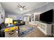 Finished basement living room with a large TV, bookshelves, and a leather sofa at 1703 Brandywine Ct, Atlanta, GA 30338