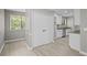 Bright dining area next to the kitchen featuring double doors and a large window at 1819 Laurel Ridge Sw Dr, Conyers, GA 30094
