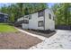 Well-kept exterior featuring a driveway, a stylish garage, and landscaped greenery at 1819 Laurel Ridge Sw Dr, Conyers, GA 30094