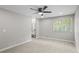 Spacious main bedroom features a ceiling fan, carpet floors, and natural light at 1819 Laurel Ridge Sw Dr, Conyers, GA 30094