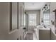Bathroom showcasing a shower with glass doors, tile flooring, and a white sink at 2174 Beecher Sw Rd, Atlanta, GA 30311