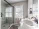 Bathroom featuring glass enclosed shower, tile flooring, and a white sink at 2174 Beecher Sw Rd, Atlanta, GA 30311