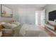 Light-filled bedroom boasts hardwood floors, a modern bed, and a wall-mounted TV at 2174 Beecher Sw Rd, Atlanta, GA 30311