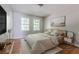 Bright bedroom featuring hardwood floors, light gray walls, and two windows at 2174 Beecher Sw Rd, Atlanta, GA 30311