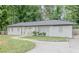 Charming white-painted home with a well-maintained front yard and welcoming yellow front door at 2174 Beecher Sw Rd, Atlanta, GA 30311