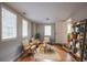 Cozy sitting room with three chairs, a round table, hardwood flooring, and natural light at 2174 Beecher Sw Rd, Atlanta, GA 30311