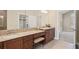 Bathroom vanity with double sinks, granite countertop, cherry cabinets, and large mirror at 803 Brookhavenrun Cir, Duluth, GA 30097