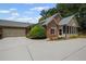 Beautiful brick home with attached garage and sunroom is surrounded by lush landscaping at 803 Brookhavenrun Cir, Duluth, GA 30097