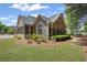 Exterior view of a stone home with lawn and landscaping at 803 Brookhavenrun Cir, Duluth, GA 30097