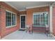 Welcoming front porch features brick accents, a bench, and an inviting entrance at 803 Brookhavenrun Cir, Duluth, GA 30097