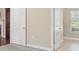 Hallway with white doors, light walls and tile and hardwood flooring at 803 Brookhavenrun Cir, Duluth, GA 30097
